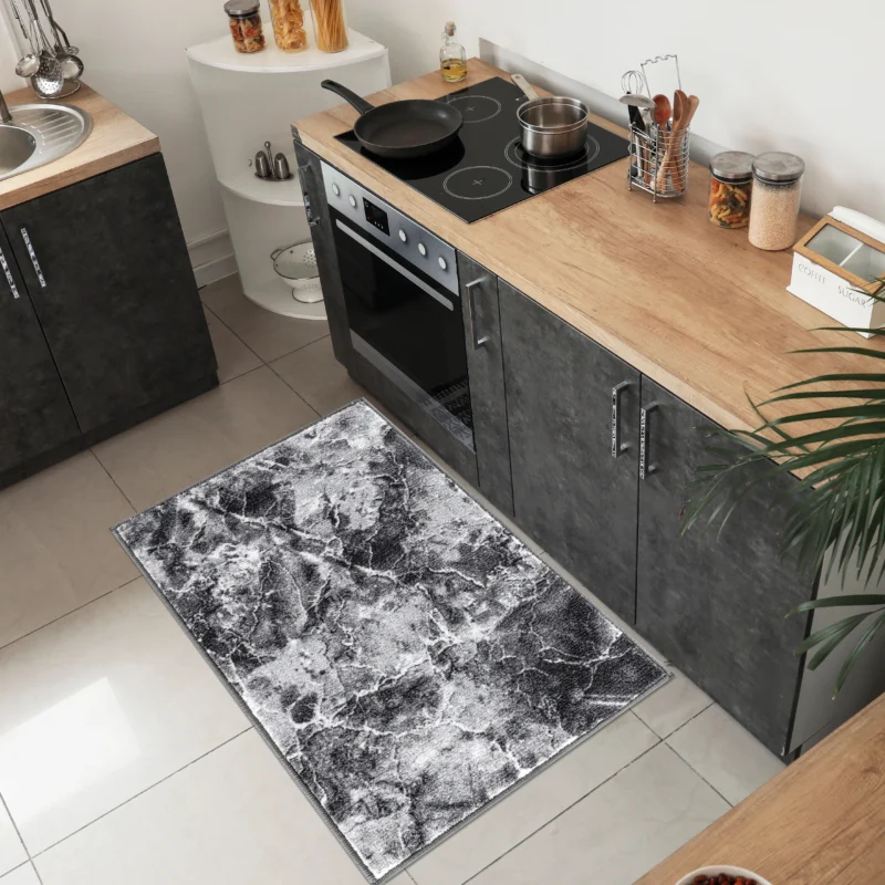 Kitchen with a black patterned rug by the counter
